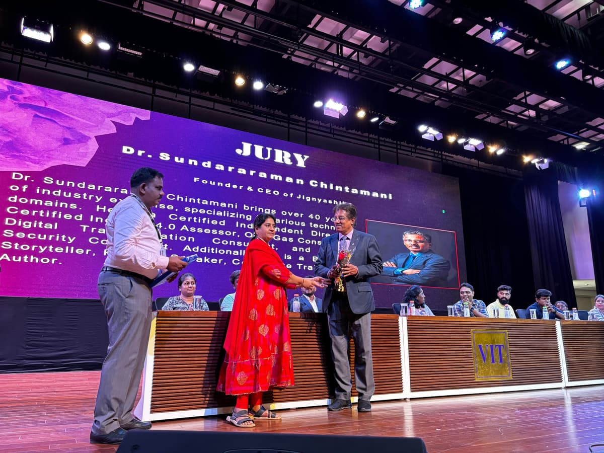 Dr. Sundararaman receiving memento on stage as Jury at Entropy hackathon VIT Chennai with bio on screen