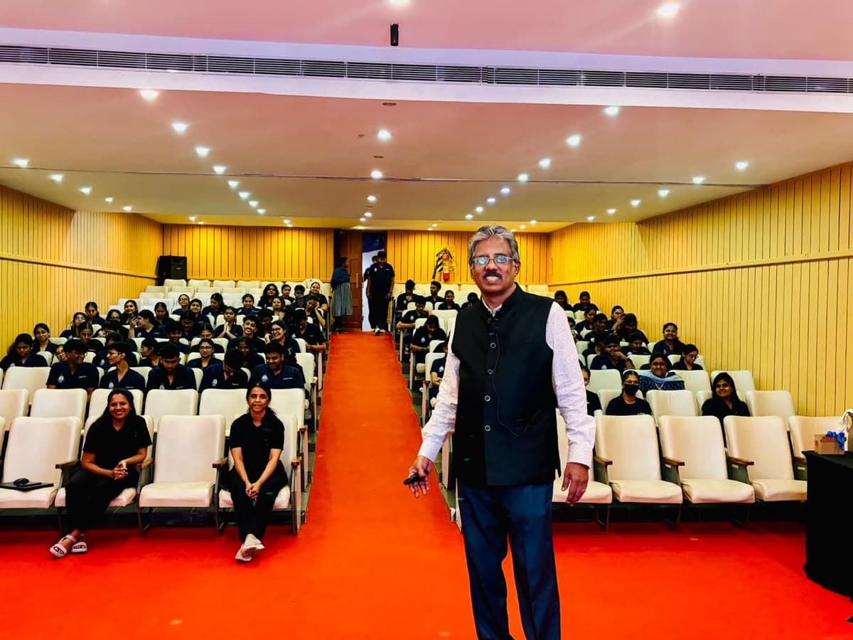 Dr. Sundararaman standing in center aisle with BDS students at Saveetha Dental College