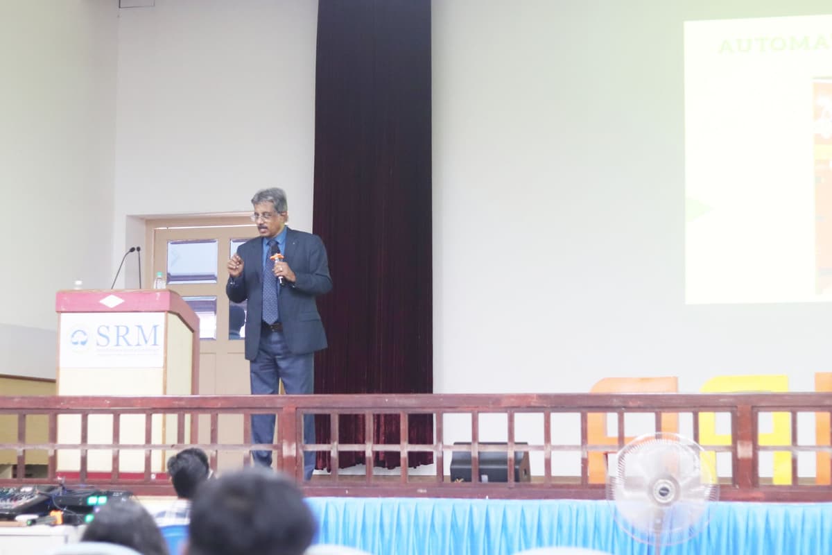 Dr. Sundararaman speaking on stage at SRM Institute auditorium