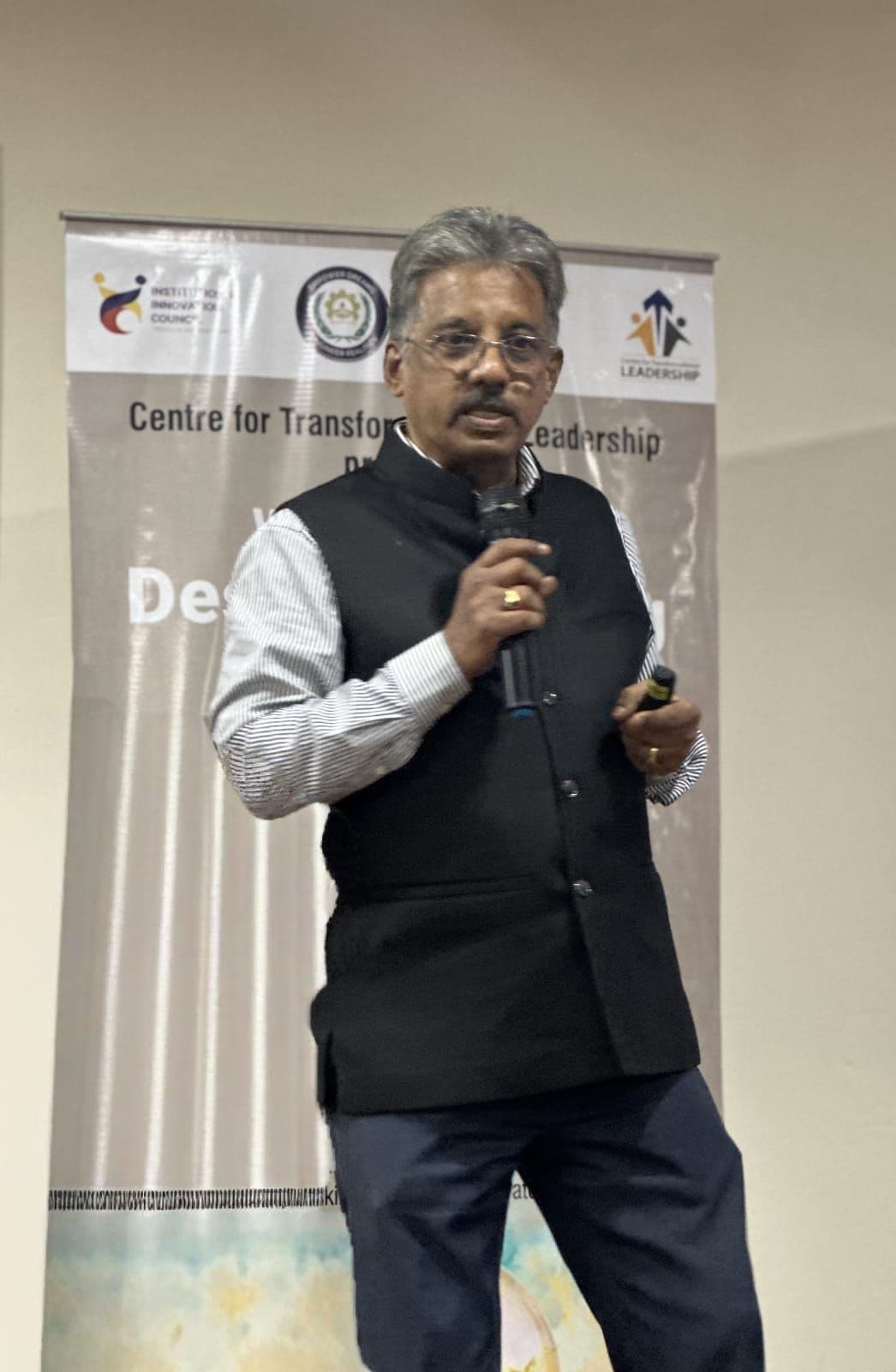 Dr. Sundararaman speaking with mic at KCG Design Thinking workshop