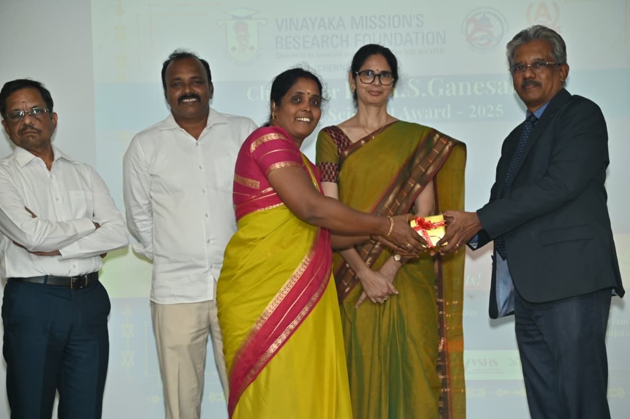 Presenting award to young scientist at Vinayaka Mission