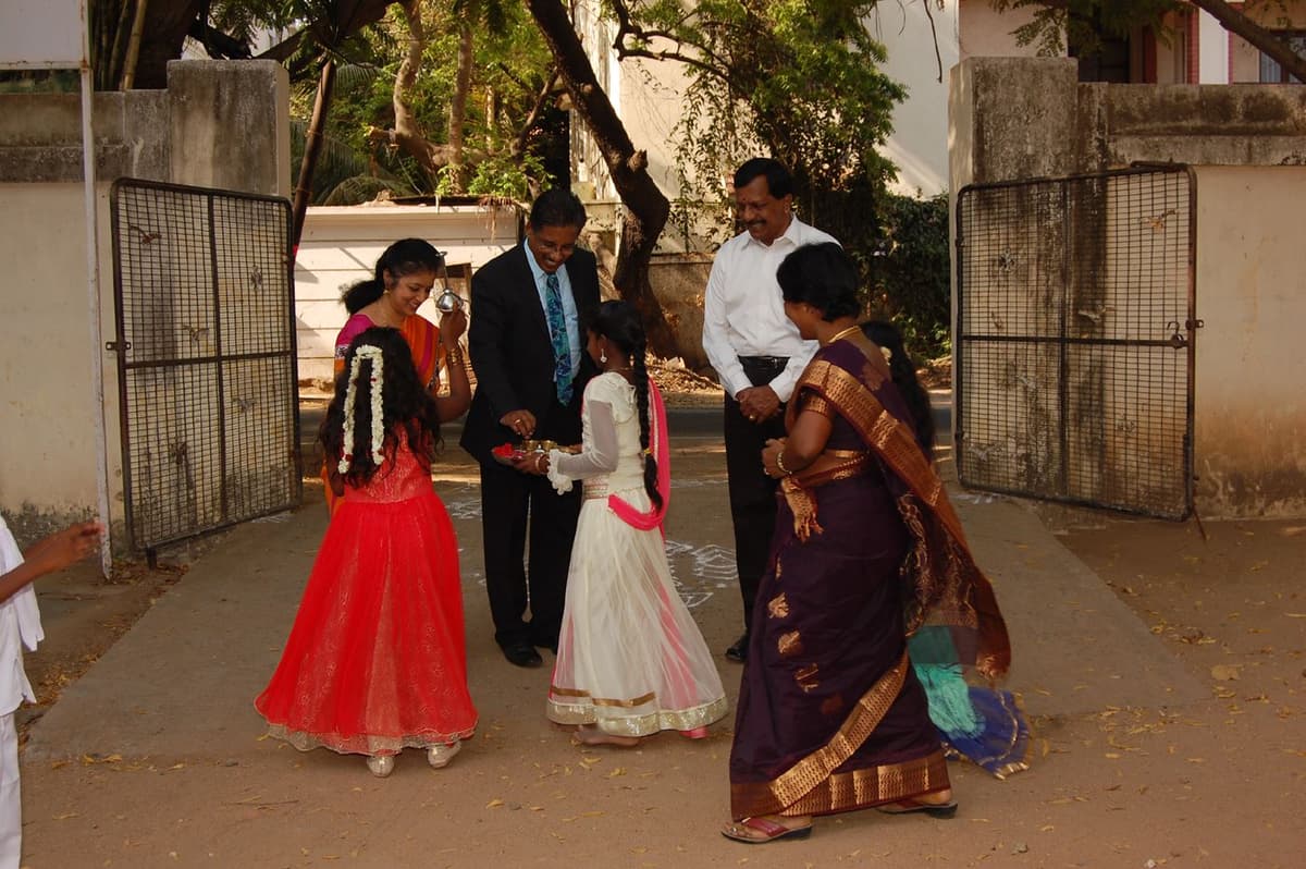 Welcome at school gate by student with Dr. Meena Muthiah at Kumararajah Muthiah School