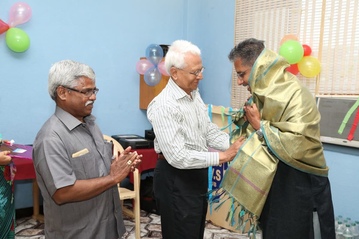 Dr. Sundararaman being felicitated with golden shawl at Suguna Vilas Sabha