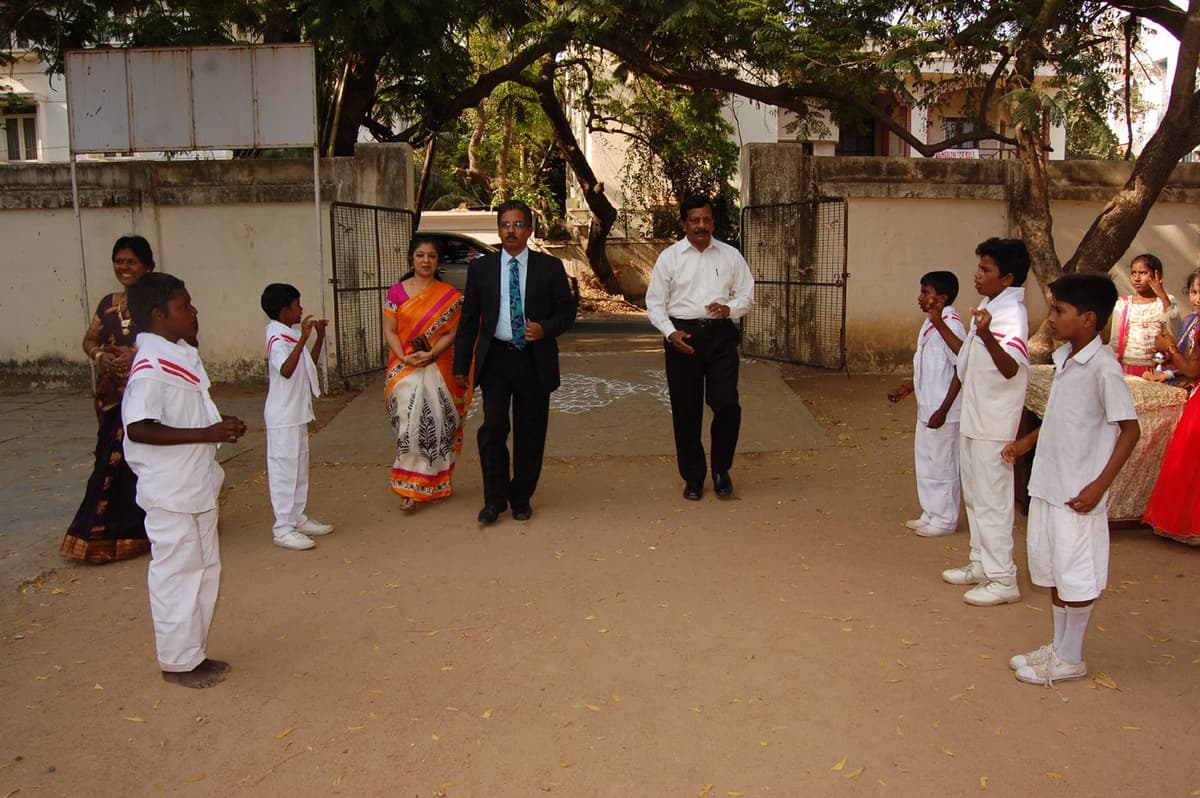 Dr. Sundararaman and Dr. Meena Muthiah walking through guard of honour at school