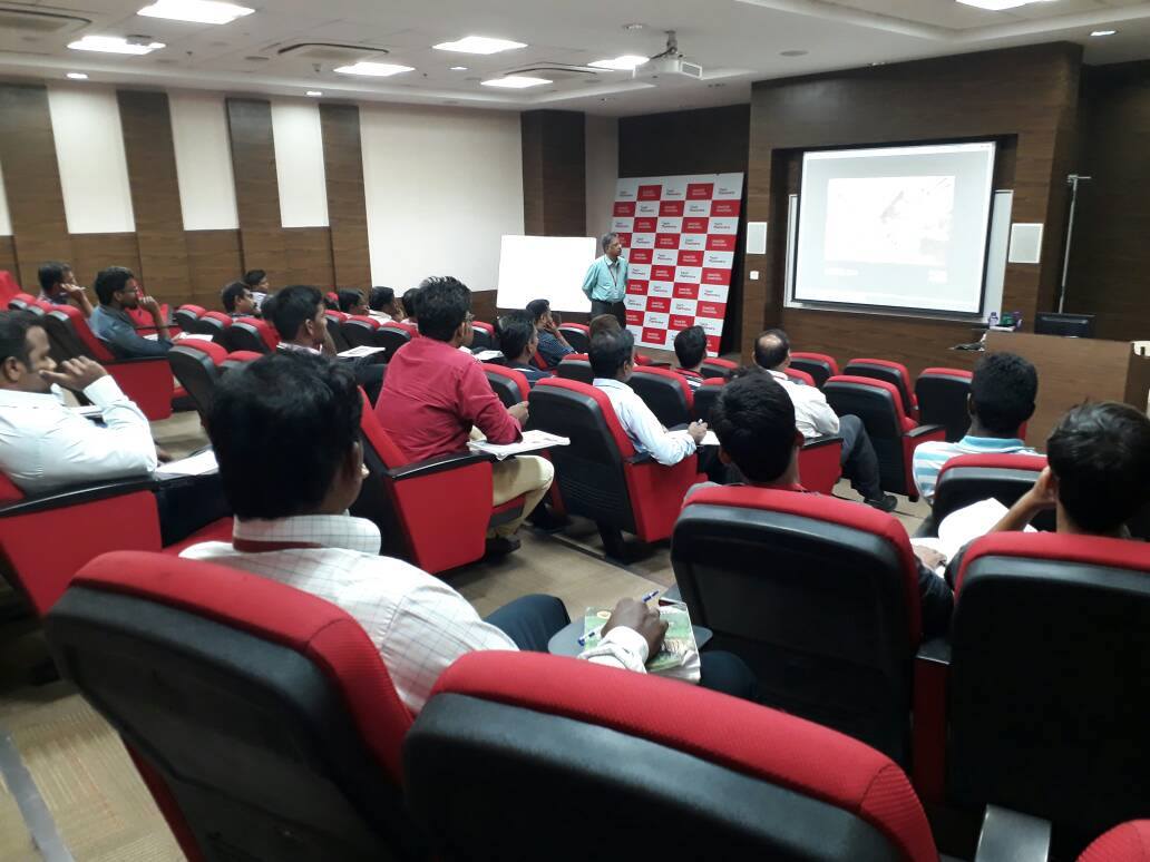 Dr. Sundararaman presenting with backdrop at Tech Mahindra
