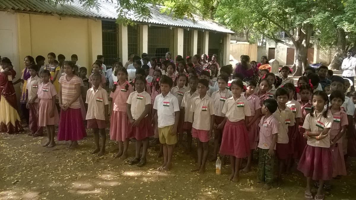 Students lined up wearing Indian flag badges on Independence Day