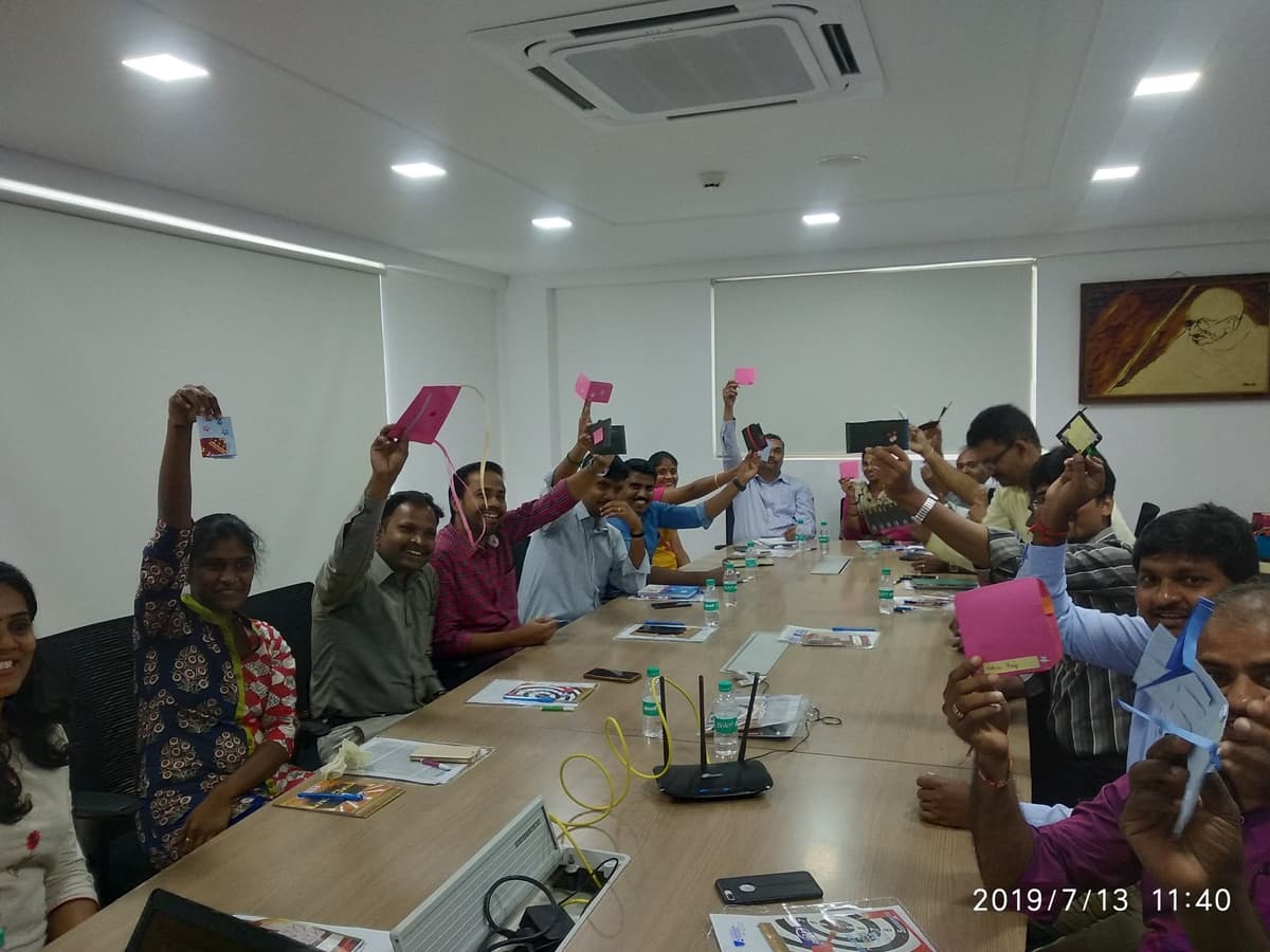 Enthusiastic participants holding up their prototypes at Design Thinking workshop MMA
