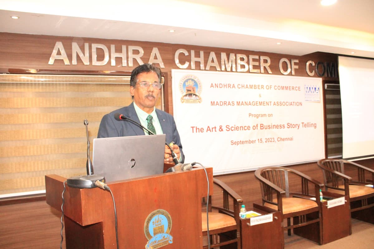 Dr. Sundararaman presenting at podium on Business Storytelling at Andhra Chamber of Commerce