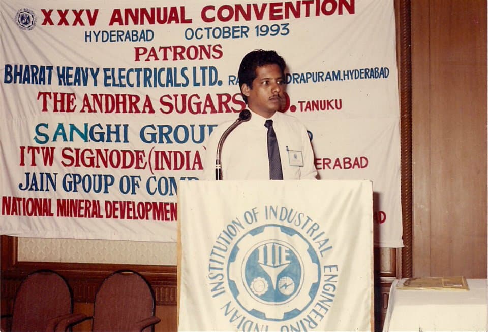 Young Dr. Sundararaman presenting paper at IIIE XXXV Annual Convention podium, Hyderabad October 1993, with Indian Institution of Industrial Engineering banner