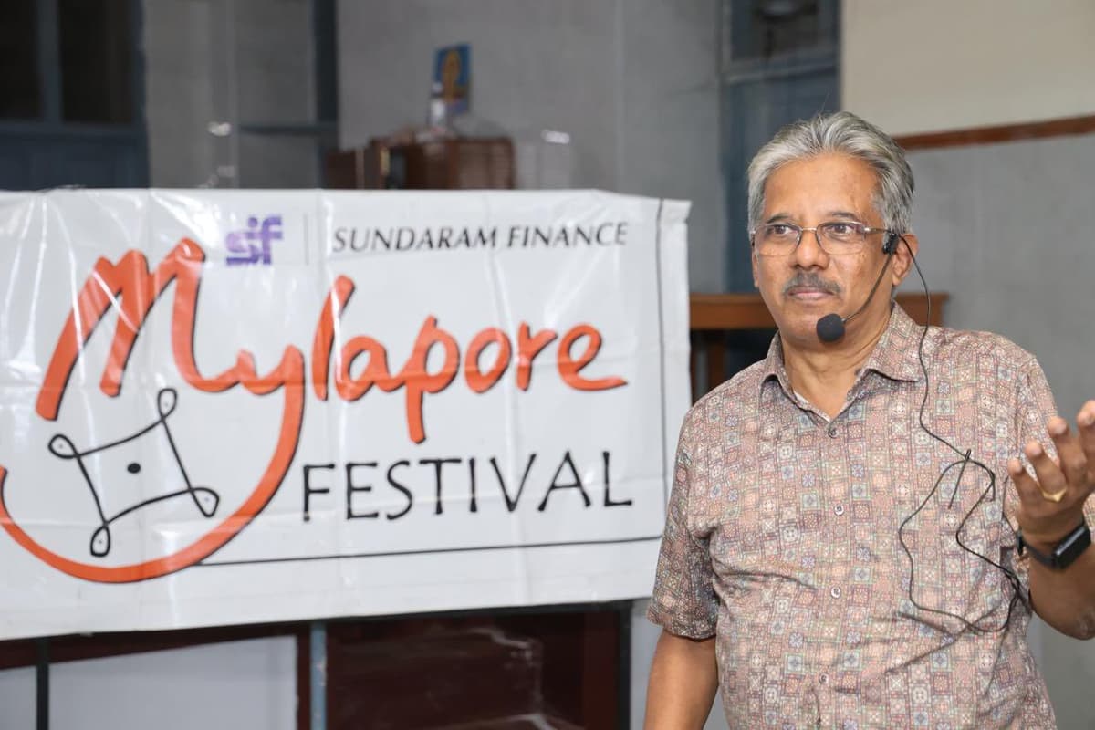 Dr. Sundararaman conducting Mylapore Quiz with headset mic at Sundaram Finance Mylapore Festival