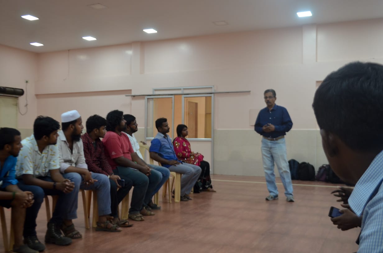 Dr. Sundararaman speaking to seated participants at team building session