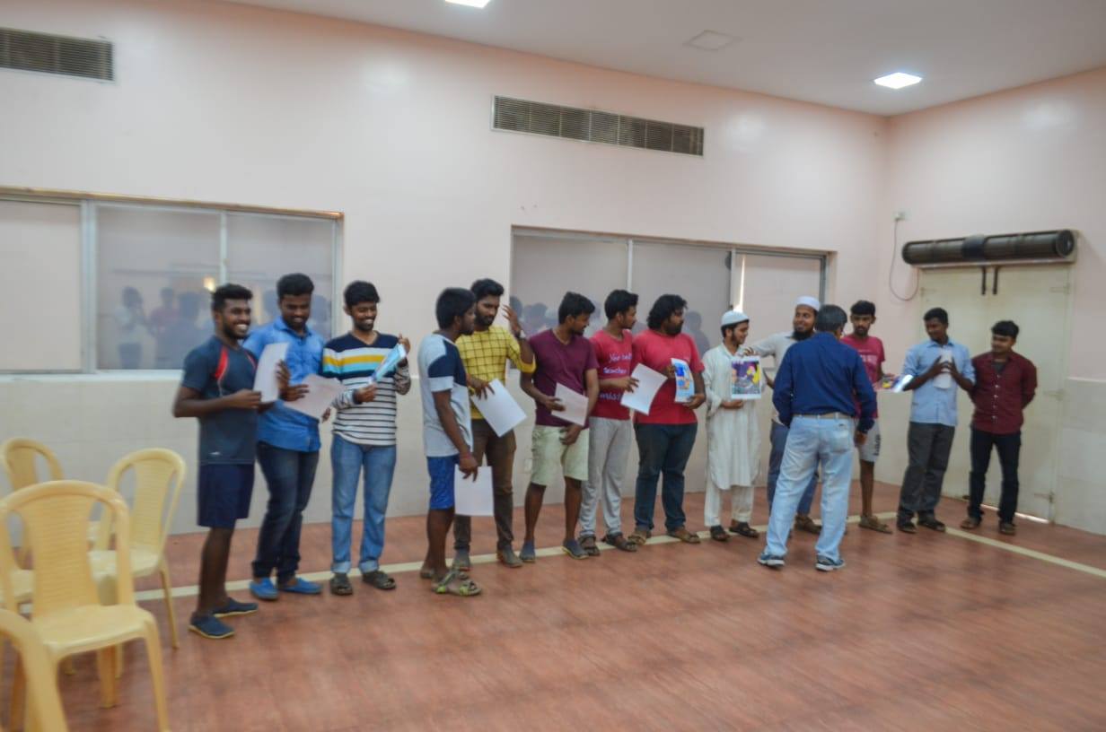 Participants lined up with papers during team building activity at MSquare Engineering
