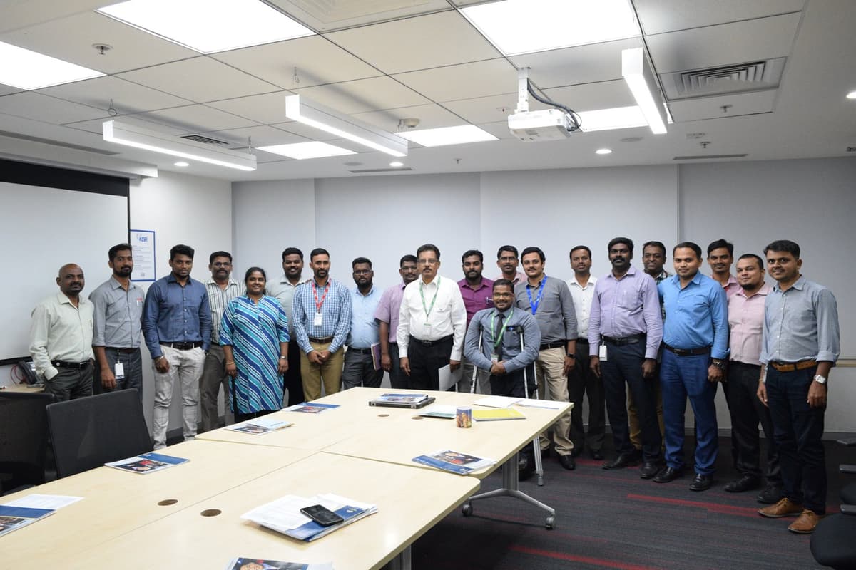 Group photo with KBR Speechcraft participants in corporate conference room